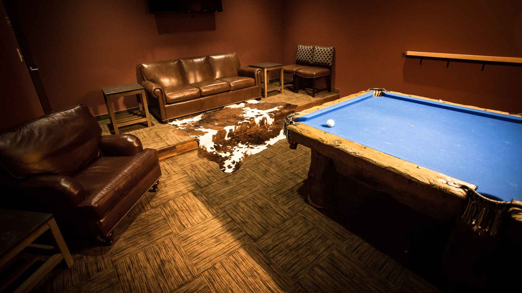 The former gym room stage, turned pool and game room (photo: Chad Shmukler). Tailwater Lodge - Game Room