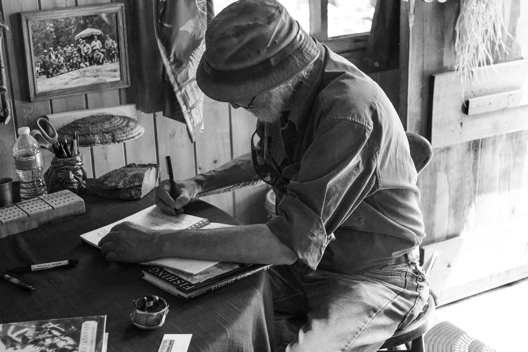 John Gierach signing the guestbook at John Voelker's cabin (photo: Tim Schulz). John Gierach signing the guestbook at John Voelker's cabin
