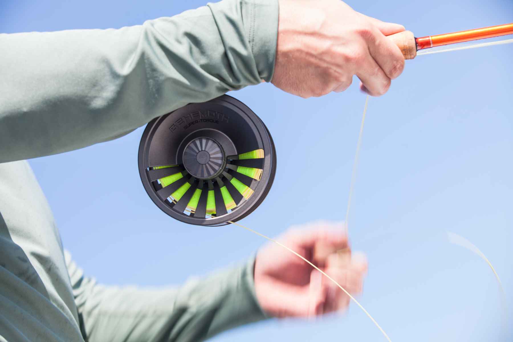 Paul Scrambles to clear line onto his Redington Behemoth reel, which is quickly being stolen by a feisty albie (photo: Chad Shmukler). redington behemoth fly reel
