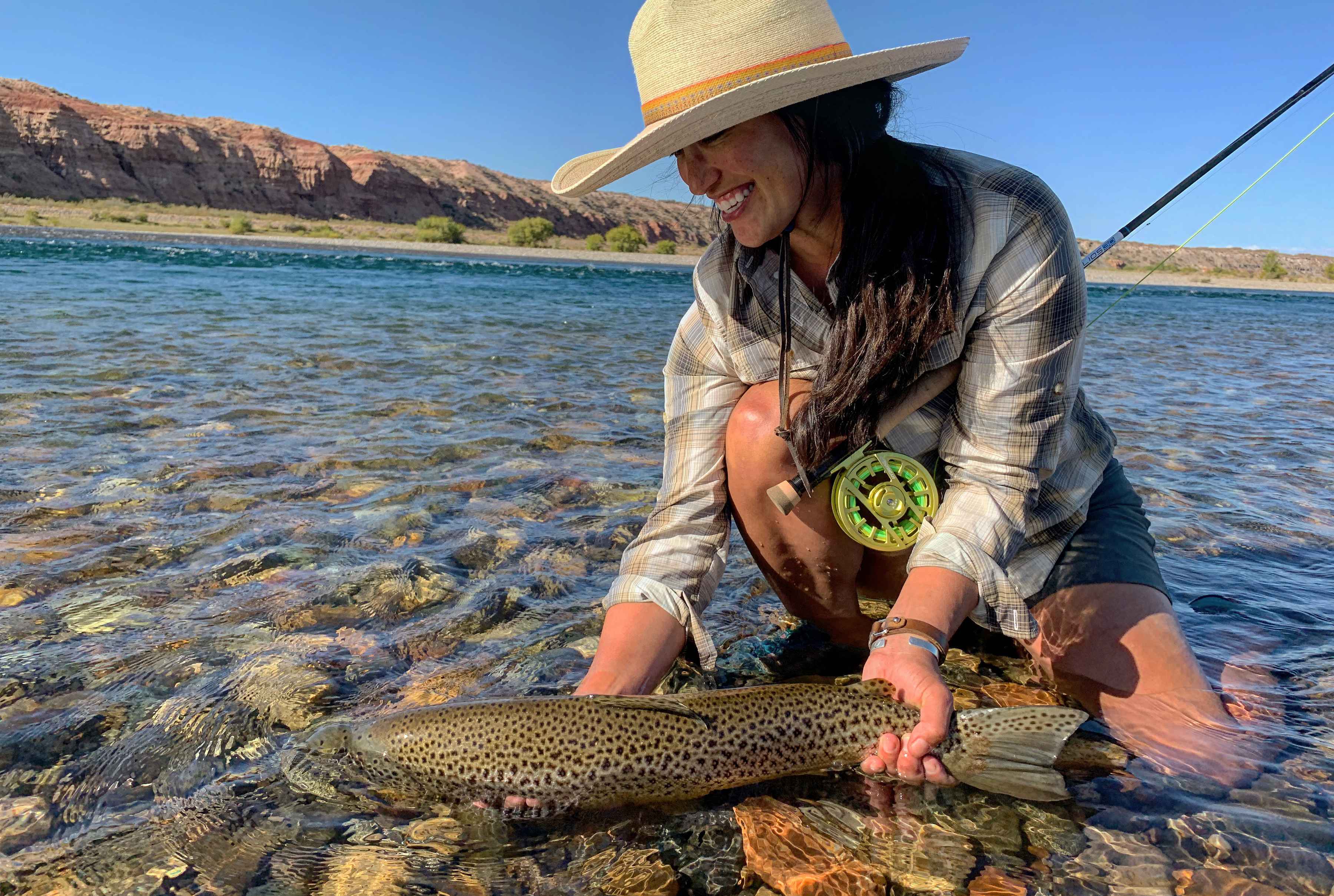 Guide and outfitter Hilary Hutcheson releasing a trophy brown trout (photo credit: Hilary Hutcheson). brown trout hilary hutcheson