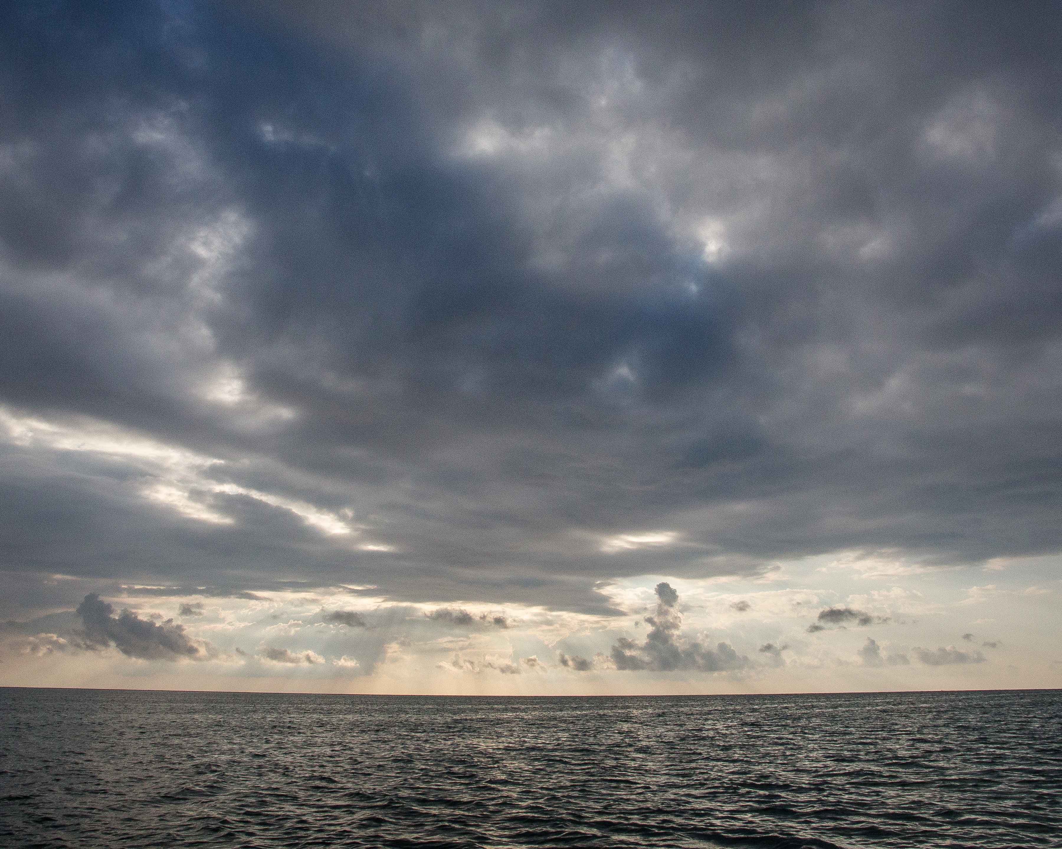 Peering out across sky the darkened lagoon in search of fleeing permit (photo: Chad Shmukler). Turneffe Atoll lagoon