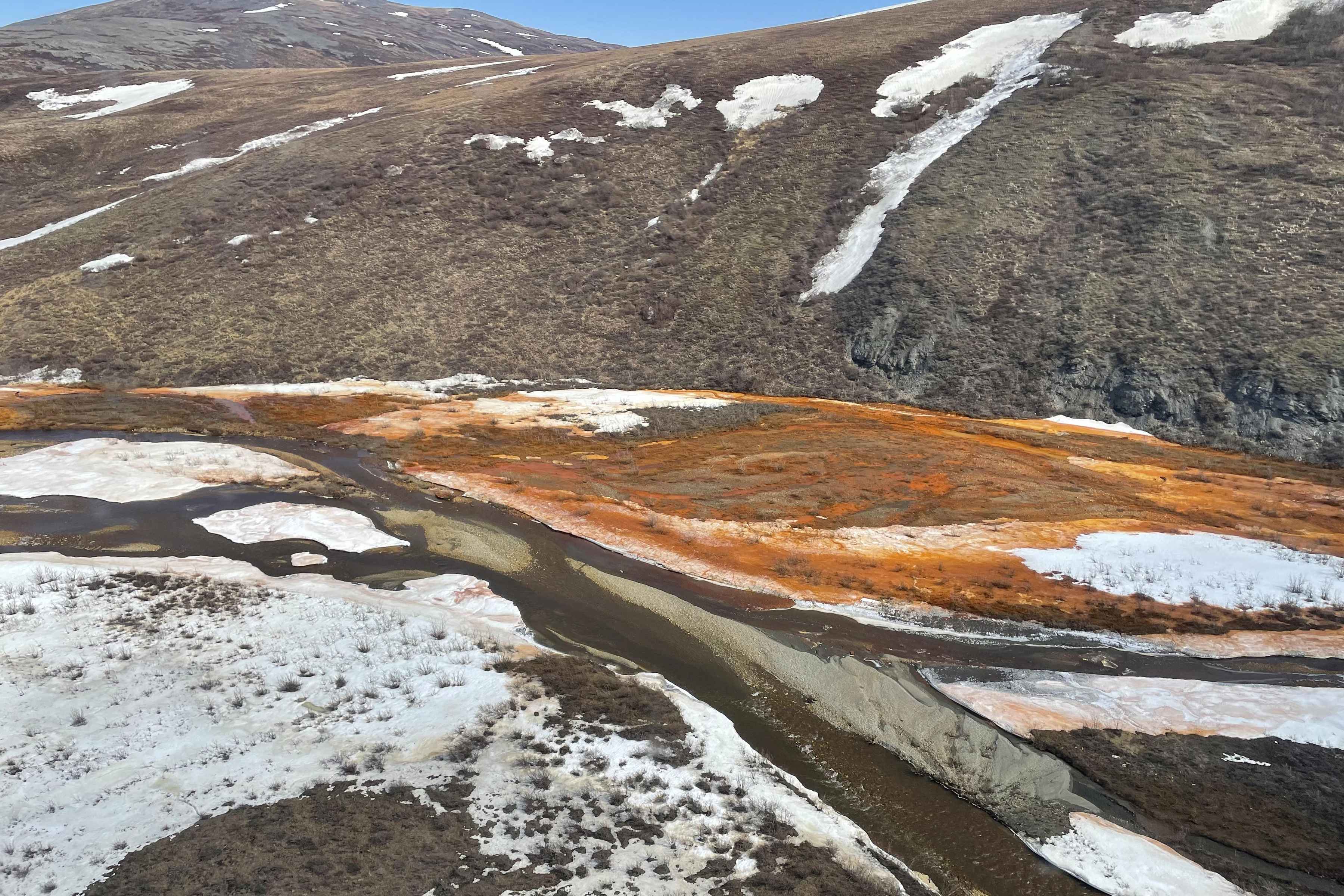 Orange water and snow in a braidplain of the Nakolikruk River (photo: Josh Koch / USGS). Orange water and snow in a braidplain of the Nakolikruk River