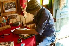 John Gierach signing the guest book at John Voelker's cabin